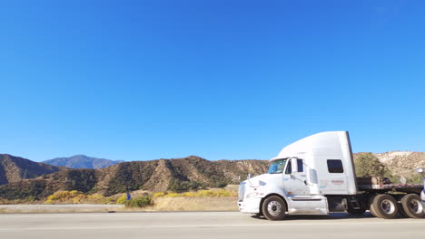 POV-Passing-semitrucks-on-mountain-highway-with-blue-sky