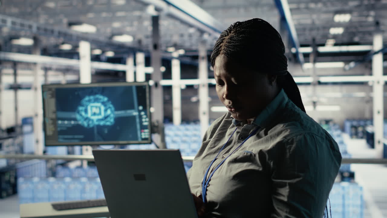 Data Center Admin Checks Ai Dashboard Using Laptop During Rigs Systems Review