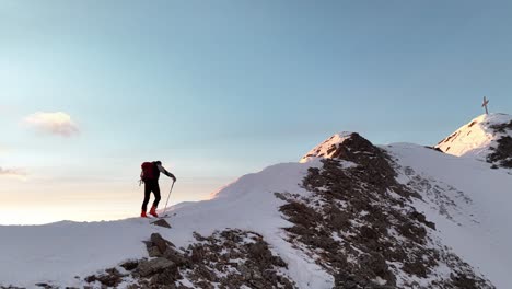 drone footage of an alpine skier ascending a mountain