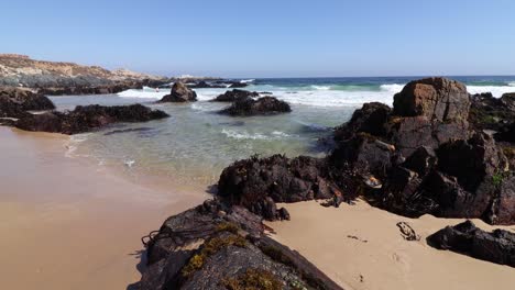 Las-Olas-Golpeaban-Implacablemente-La-Costa-Rocosa-De-La-Playa-Cubierta-De-Guijarros,-Su-Movimiento-Rompiente-Producía-Una-Combinación-Encantadora-De-Salpicaduras-Y-Ecos