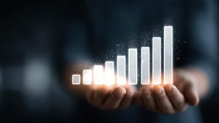 Una rappresentazione visiva della crescita finanziaria: mani che sorreggono un grafico a barre ascendente con effetti scintillanti per illustrare il progresso e il successo