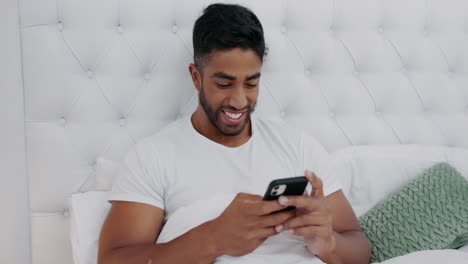 Happy,-man-and-texting-on-cellphone-in-bedroom