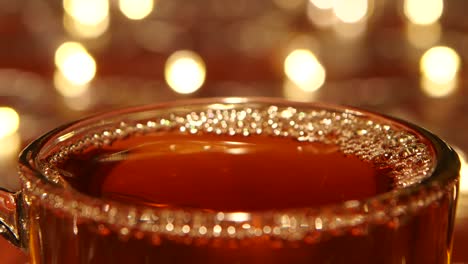 close-up of a hot beverage with bubbles and bokeh lights