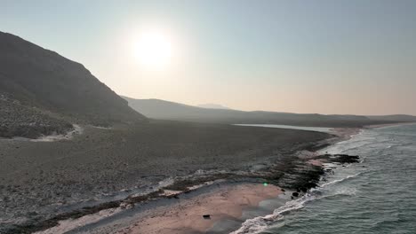 ocean waves on the shoreline of delisha beach during golden hour in yemen