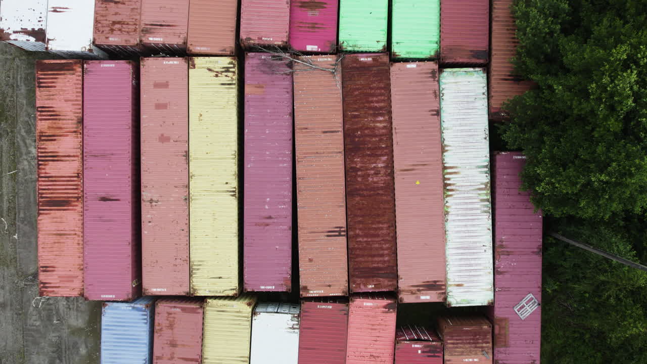 Aerial: containers in Hafrestroms Foretagspark during the day, industry in Asensbruk, Dalsland, Sweden, top down drone shot