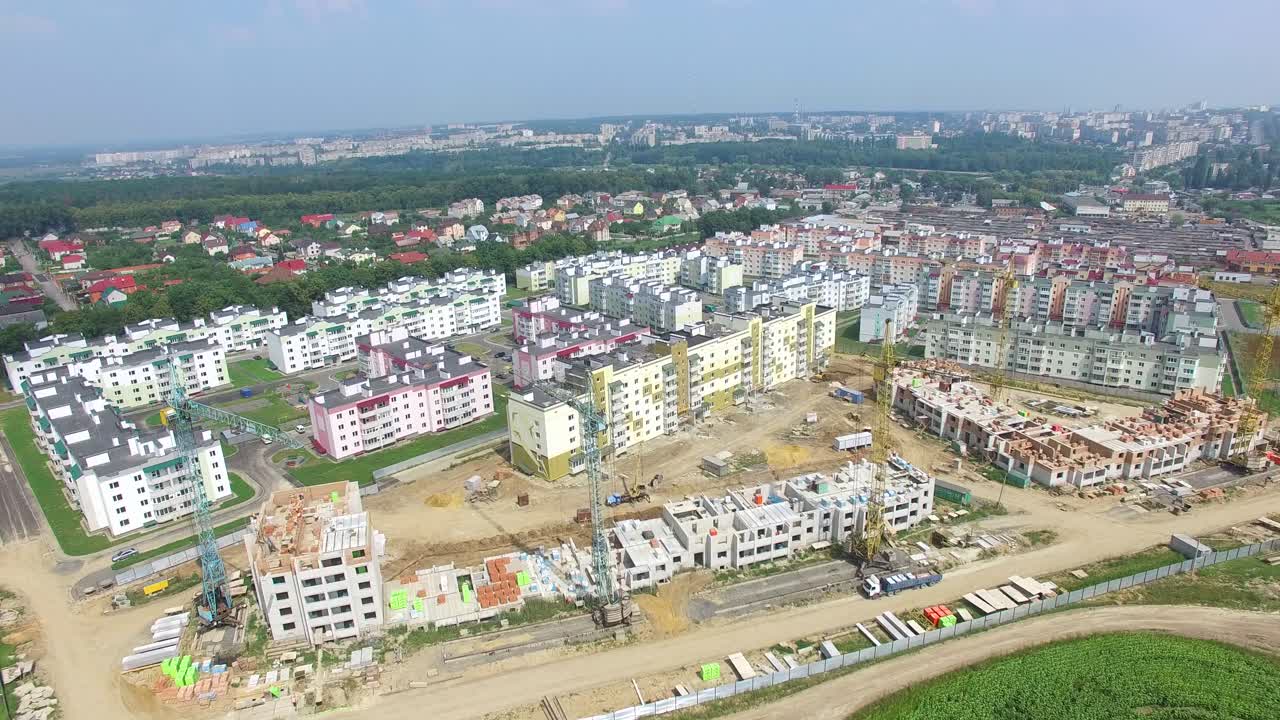 building materials and equipment are located on the site of the construction of modern high-rises. Aerial view