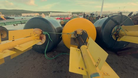 Water-buoys-resting-flat-on-an-asphalt-surface,-captured-in-a-small-coastal-town-in-Spain,-showcasing-the-concept-of-maritime-tranquility-and-coastal-charm