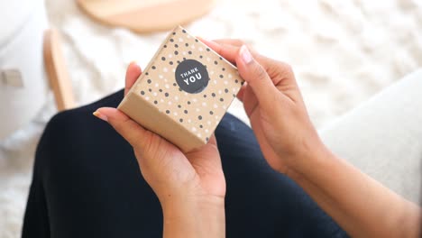 Hands opening a polka dot gift