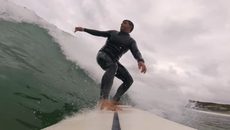 goofy surfer riding blue wave getting good snap against the lip at slow motion mode, sintra 2022