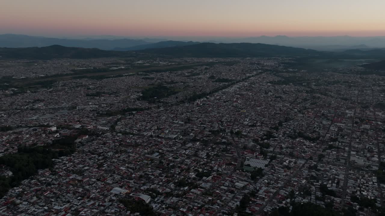 DRONE: PANNING SHOT OF URUAPAN, MICHOACÁN CITY AT SUNSET