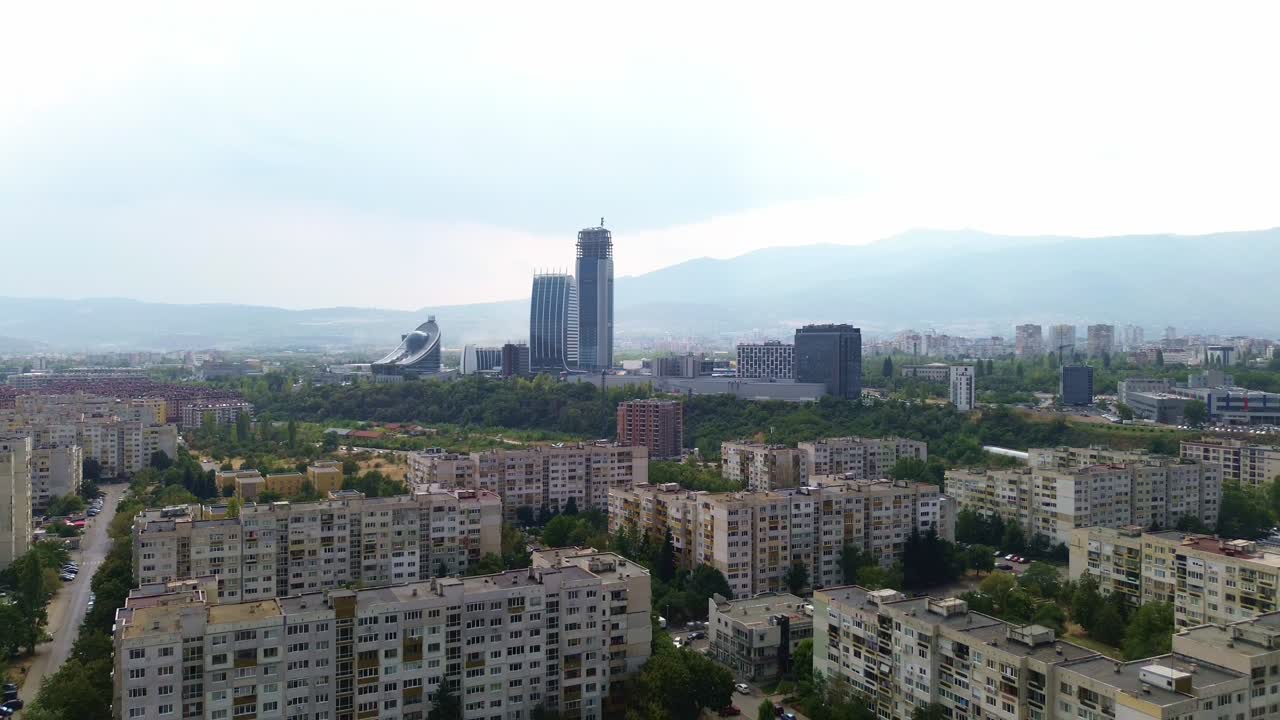 drone shot, flying down on a bright summer day in Sofia, Bulgaria, looking at the only skyscrapers in the city