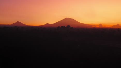 gimbal up revealing mount agung at awesome orange sunrise