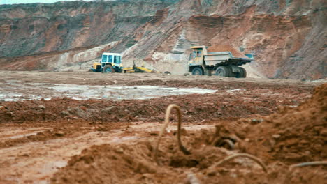 Large-yellow-dumper-truck-in-open-cast-mine-landscape.-Dirty-tipper-truck