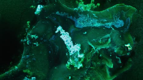 alcohol ink flowing in layers, glowing green tones, abstract close-up texture art