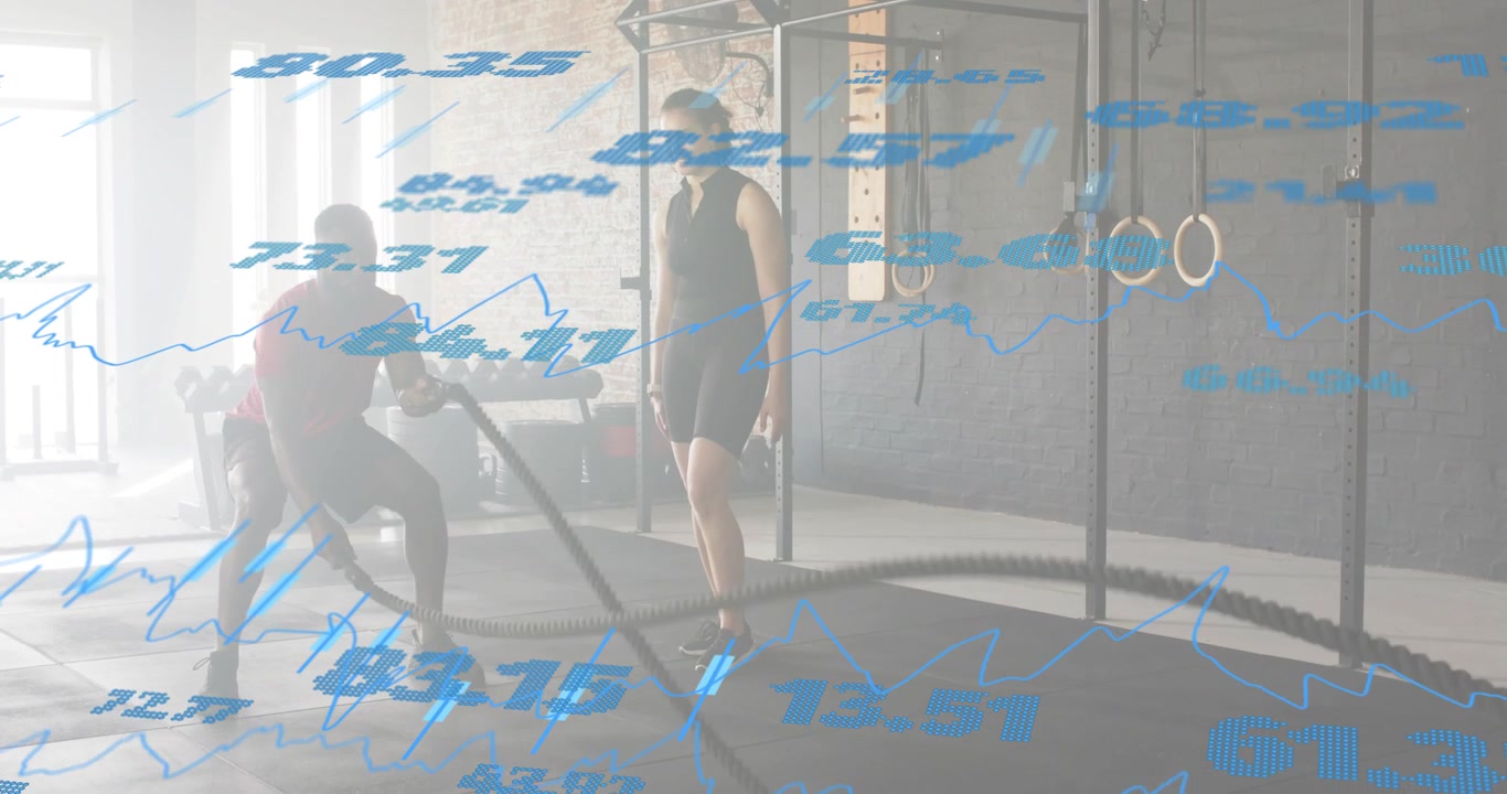 Trainee gripping battle ropes making waves in fitness as trainer joining sync waves refining form