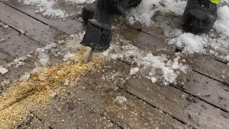 Cutting-wood-with-a-bayonet-saw-during-winter,-close-up-following-shot