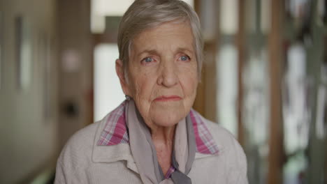portrait-of-elderly-caucasian-woman-standing-looking-pensive-contemplative-thinking-memories-in-retirement-home-background