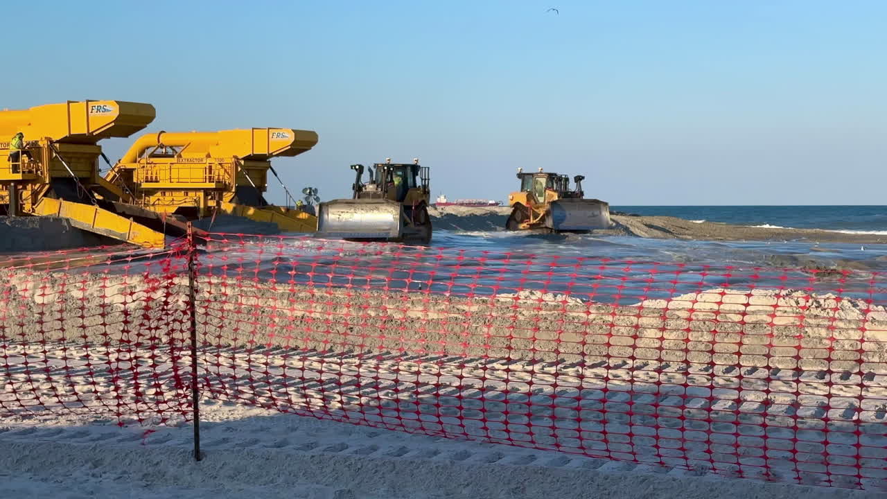Construction zone fencing, heavy equipment working beach replenishment