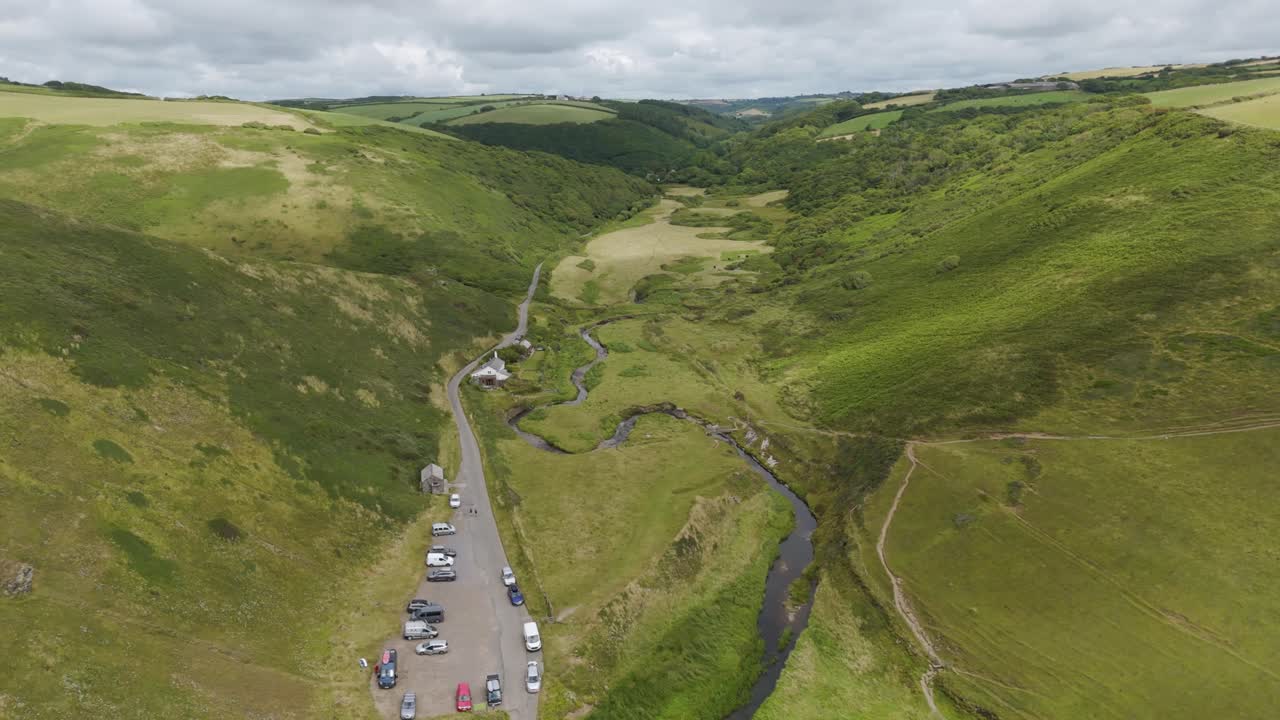 Aerial View of a Scenic Valley with River and Parking Lot