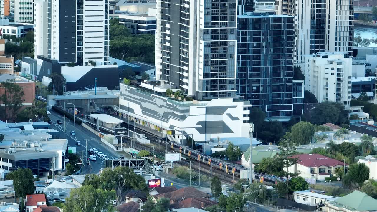 Aerial static shot of Brisbane Train as it drives through Brisbane's inner suburbs into Milton Train station