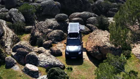 Aerial-view-of-Safari-vehicle-in-an-adventurous-wild-camping-location