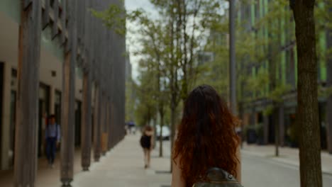 solo women tourist with backpack exploring european city on sunny afternoon