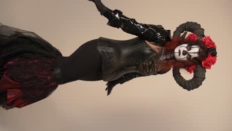 woman in day of the dead costume with horns and roses