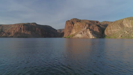 aerial - drone tilt up over desert lake to reveal mountain