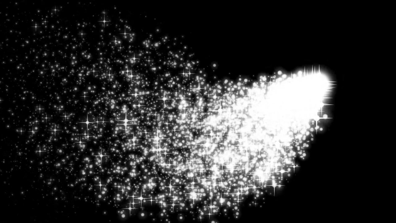 Scia di particelle bianche scintillanti che si muove su uno sfondo nero.