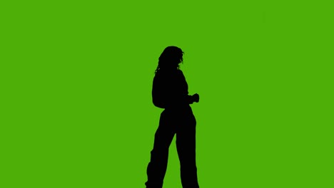 studio silhouette of woman dancing against green background 4