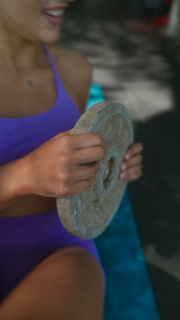 woman exercising outdoors with weights