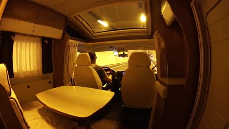 Man-driving-on-a-road-through-the-tunnel-in-the-Camper-Van.-Caravan-car-Vacation.-Family-vacation-travel,-holiday-trip-in-motorhome