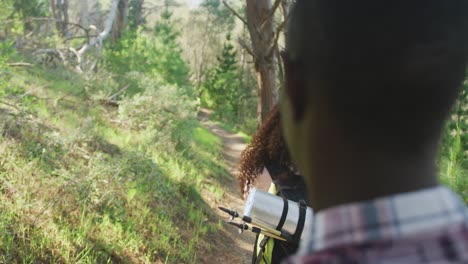 smiling diverse couple taking photo and hiking in countryside