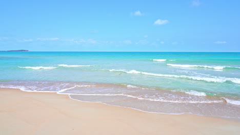 waves swell on the sand of a tropical beach