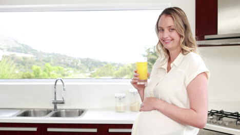 pregnant woman drinking orange juice