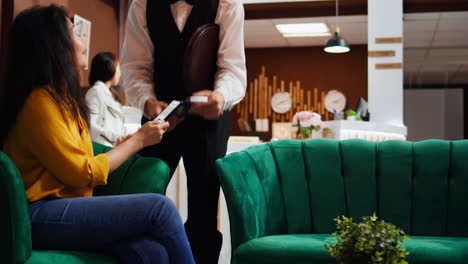 customer using nfc mobile payment to buy coffee from bar