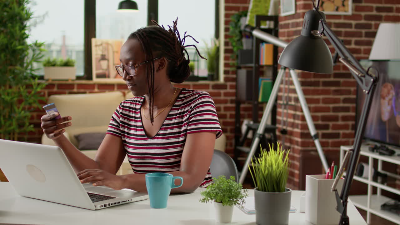 Woman shopping online with credit card and laptop at home