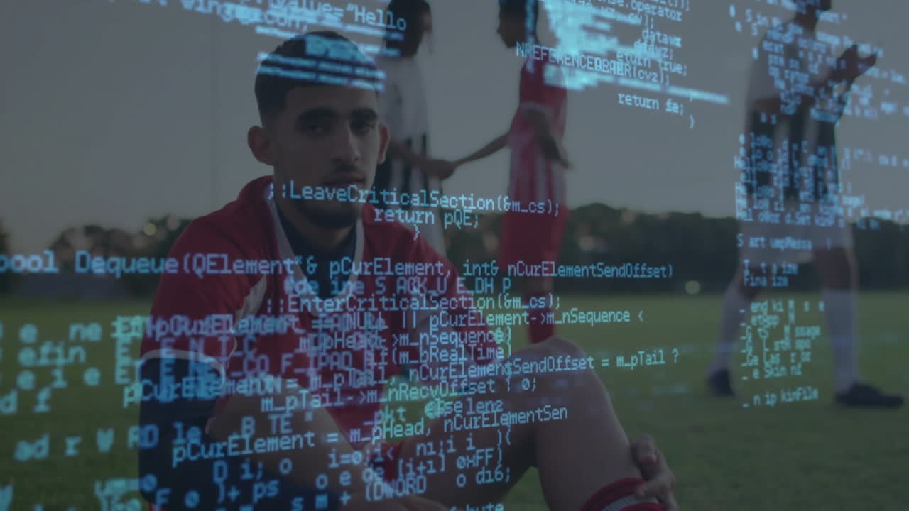 Male soccer player sitting on grass pitch, gesturing sports strategy showing floating data charts