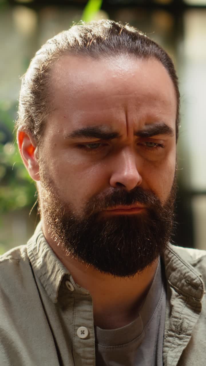 Vertical Video Male frowning, laptop screen, disoriented and uncertain, man contemplating
