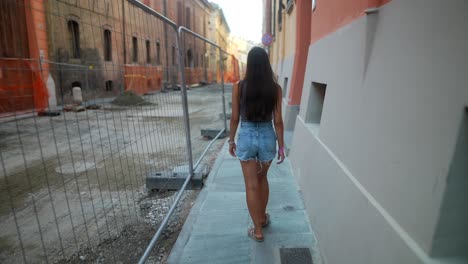 woman walking down a city street during construction