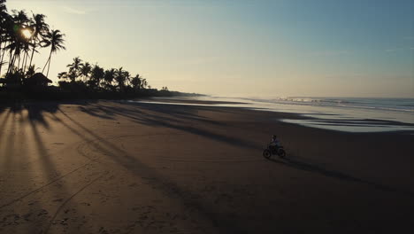 motorcycle ride on the beach at sunrise/sunset