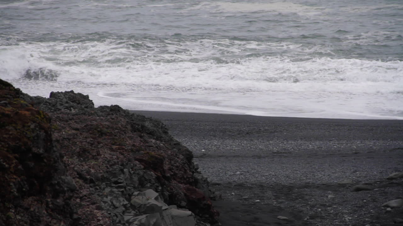 Waves Splash against Shore on Icelandic Black Sand Beach