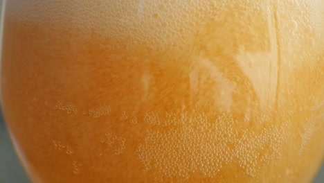 close up of beer glass being filled in slow motion