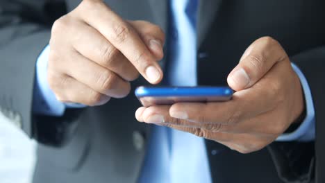 man using a smartphone in a suit