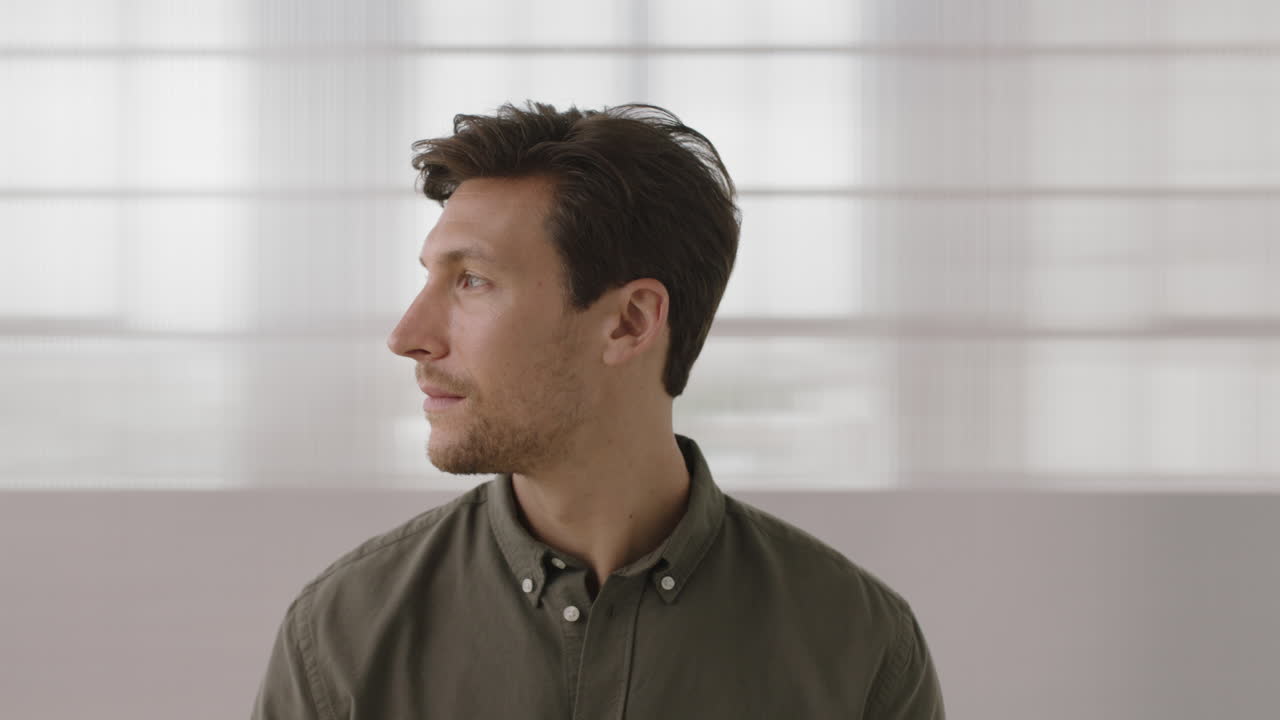 close up portrait of young entrepreneur man looking serious pensive at camera turns head