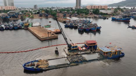 Crane Dredging Debris into Barge