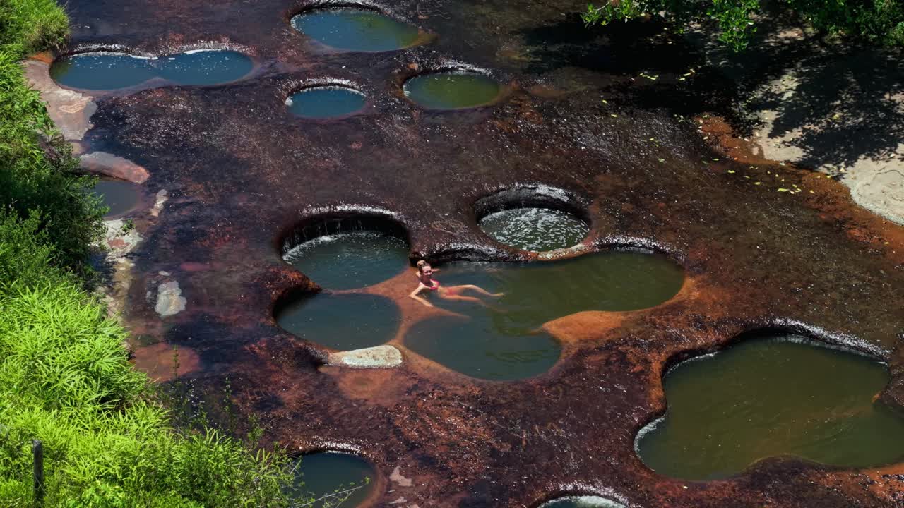 Overhead drone shot of the unique natural swimming pools of las gachas river in colombia