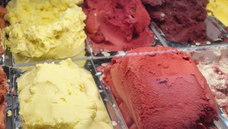 close up of different flavors of ice cream in a display case