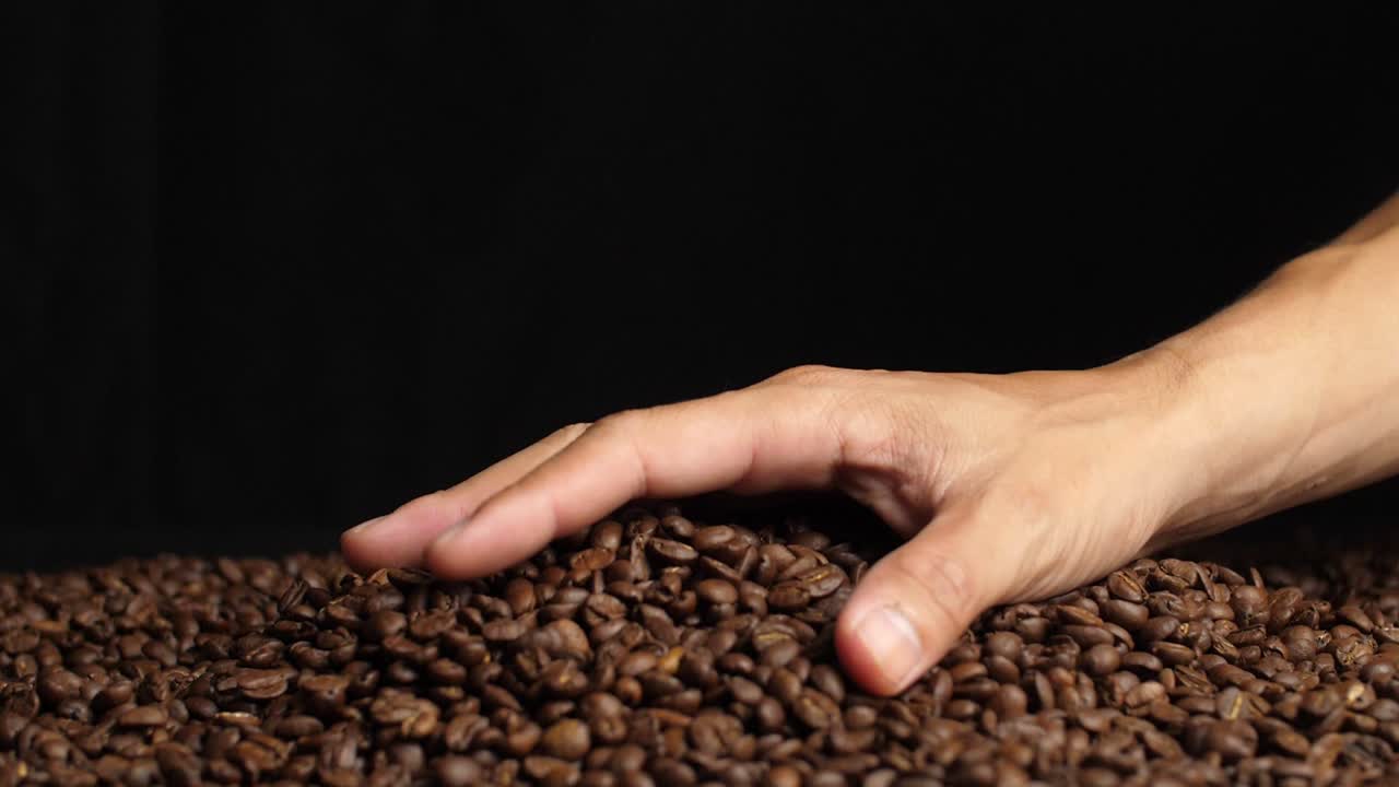 Hand Holding Coffee Beans And Falling Down, Slow Motion