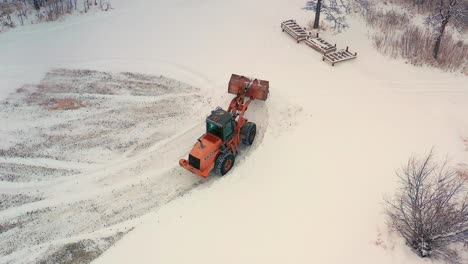 piling up snow with a front end loader